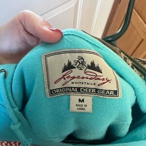 Teal colored women’s medium hoodie. Regendary white tails (original deer gear).